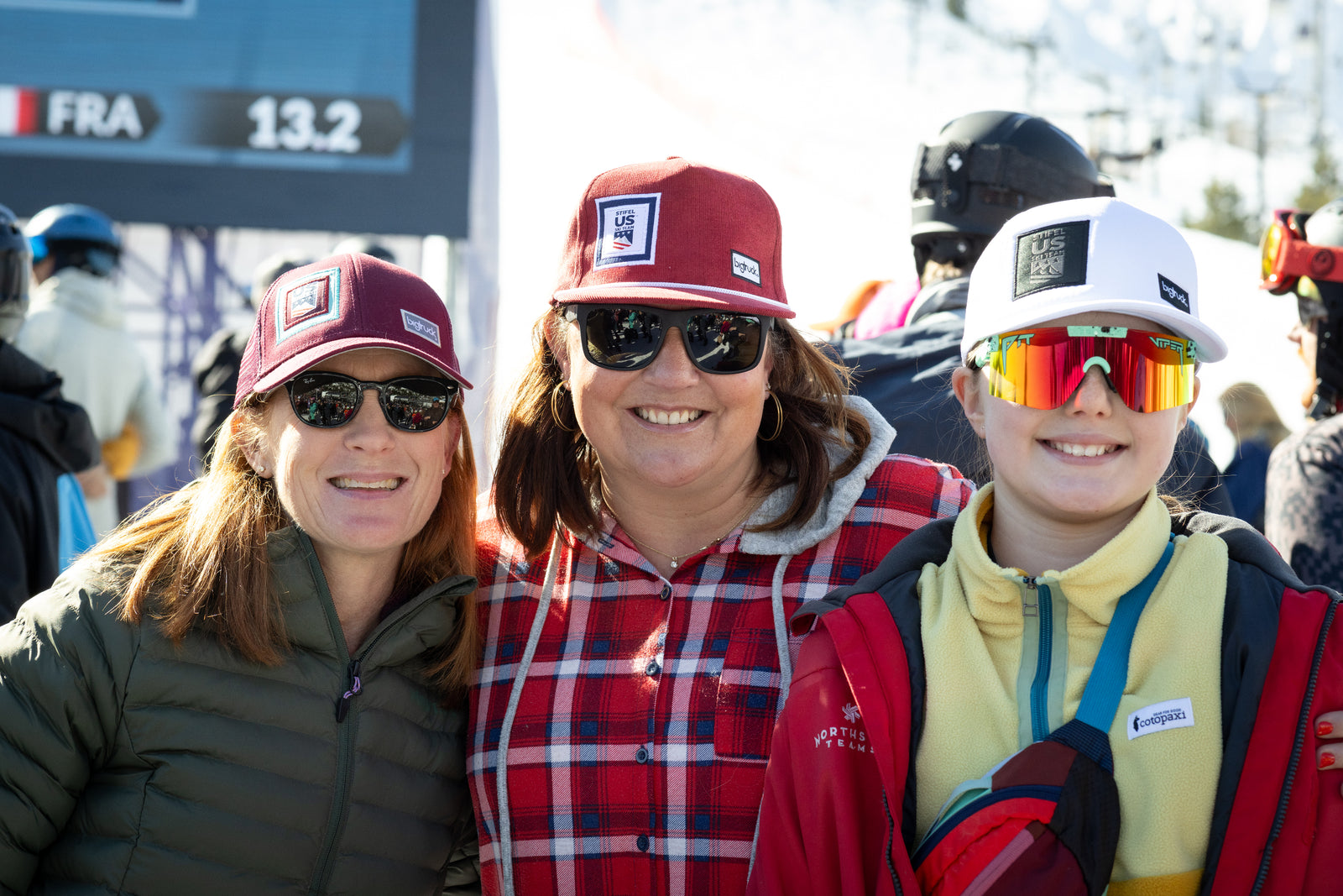 Three People Wearing US Ski Hats